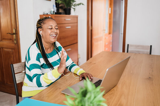 African Senior Woman Doing Video Call During Coronavirus Lockdown - Old Person Having Fun With Technology Trends - Social Distance Concept - Focus On Face