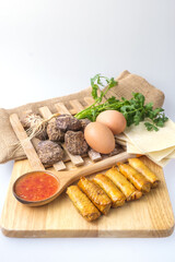 Fried chinese spring rolls with sweet chili sauce.