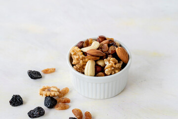 mixed nuts in bowl - on white background - copy space