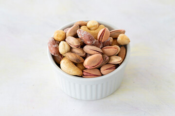 mixed nuts in bowl - on white background