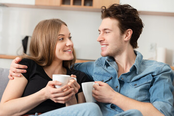 Obraz na płótnie Canvas Smiling couple spend time together at home