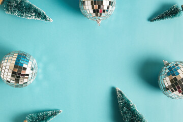 Christmas minimal festive background with disco ball, toy tree. Abstract christmas background shiny blue ai aqua. Flat lay. Top view. Copyspace.