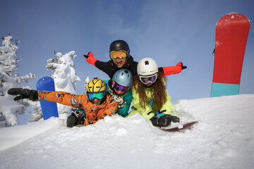 Group of happy friends snowboarders having fun