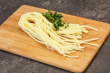 Chechil spaghetti cheese over board