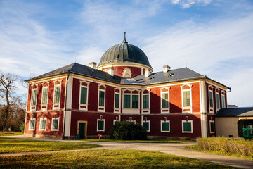 Veltrusy Rococo castle with park and garden, Romantic baroque chateau red with white windows in sunny autumn day, Central Bohemia, Czech republic