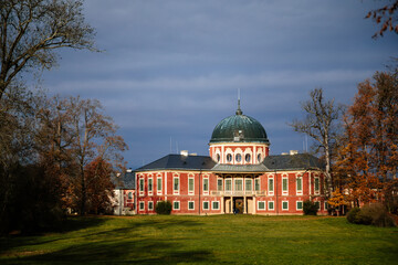Veltrusy Rococo castle with park and garden, Romantic baroque chateau red with white windows in sunny autumn day, Central Bohemia, Czech republic