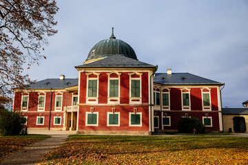 Veltrusy Rococo castle with park and garden, Romantic baroque chateau red with white windows in sunny autumn day, Central Bohemia, Czech republic