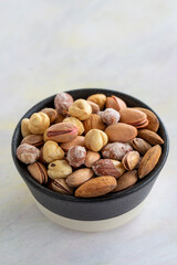 Fototapeta na wymiar mixed nuts in bowl - on white background