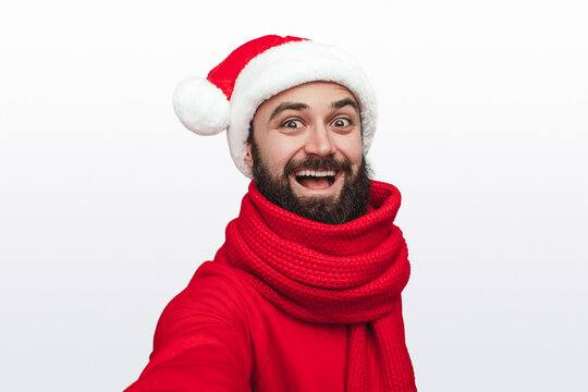 Excited man in Santa hat looking at camera