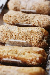 
Delicious eclairs with vanilla cream close up
