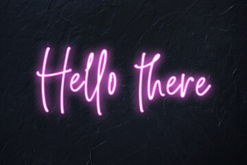 Hello there written in pink neon style on black wall background © Delphotostock