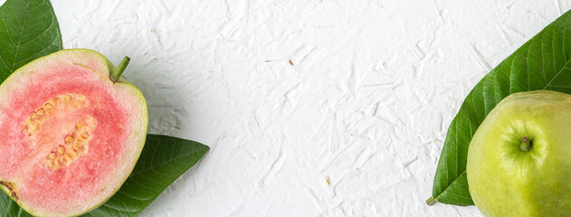 Top view of beautiful red guava with fresh green leaves.