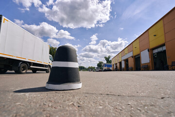 Road blocker at a car wash. Black and white traffic cone.