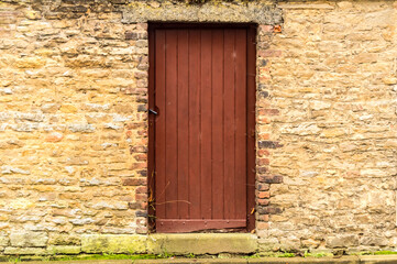Fototapeta na wymiar Old wooden door in the stone