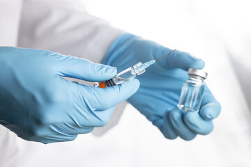 Doctor, nurse, scientist, researcher hand  holding flu, measles, coronavirus, covid-19 vaccine preparing for human clinical trials vaccination shot, medicine and drug concept.