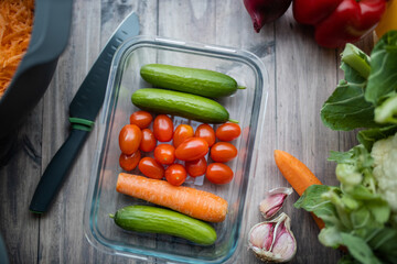 Carrots, zucchini, tomatoes, and more vegetables on a wooden table