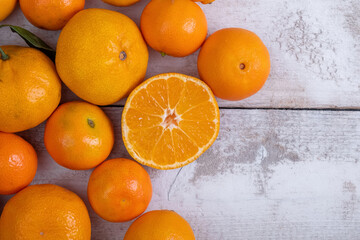 Ripe tangerines top view on a wooden background. Free space on the right