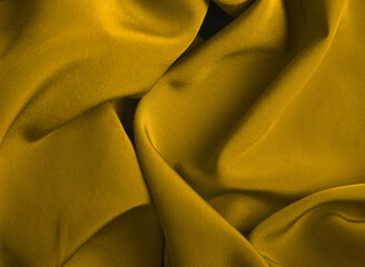 Fabric in trendy gold color. Close-up. View from above.
