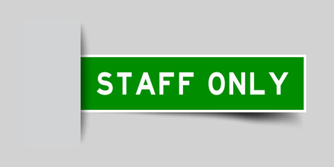 Inserted green color sticker label with word staff only on gray background