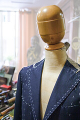 Male jacket basted on the mannequin in the tailor's shop