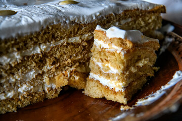 Close up view of piece of homemade honey cake on a dark background. Soft selective focus.