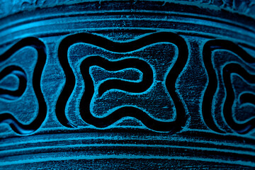 Ancient patterns and paintings on a clay pot or vessel. Abstract background.