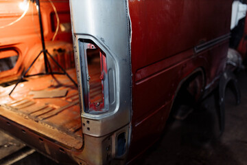 Fototapeta premium body repair of a red truck, welding of car body elements.