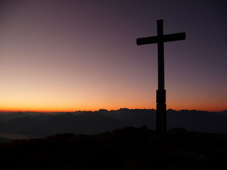 Summit cross at sunset Krottenkopf mountain, Bavaria, Germany