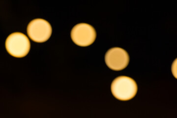 Defocused garland lights, Bokeh effect. Sparkling and fairy background. Christmas and New Year holidays concept.