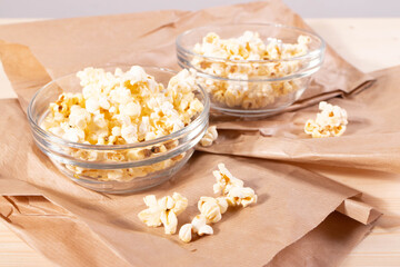 crispy golden ready to eat popcorn in a glass bowl. close up shot. 