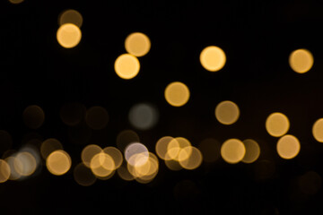 Defocused garland lights, Bokeh effect. Sparkling and fairy background. Christmas and New Year holidays concept.