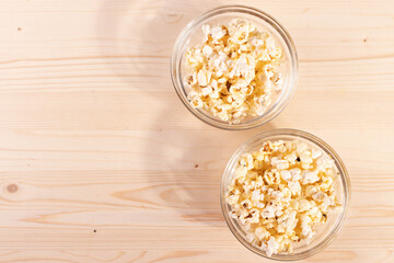 crispy golden ready to eat popcorn in a glass bowl. close up shot. 