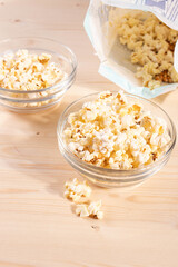 crispy golden ready to eat popcorn in a glass bowl. close up shot. 