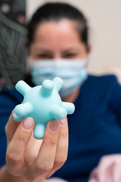 Close-up Of Fake Coronavirus Replica Held By Sick Woman With Mask