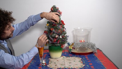 spend christmas alone away from home and family - man 40 years old  with mask in the apartment,  lifestyle at home during  lockdown  Covid-19 Coronavirus quarantine - video call with parents