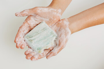 Female hands holding a soap.