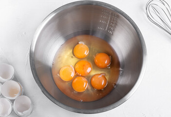 Step by step recipe of sponge cake. Step 2. Breaking eggs into the bowl to make the dough. Top view