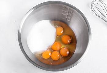 Step by step recipe of sponge cake. Step 3. Mix eggs and sugar in the metallic bowl to make the dough. Top view