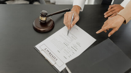 Lawyer with lawsuit meeting with client discussing with contract agreement at courtroom..