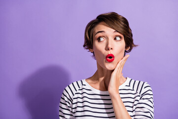 Portrait of funky sweet short brunette hairdo girl arm cheek look empty space wear stripped pullover isolated on violet color background