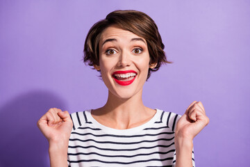 Portrait of funky cute short brunette hairdo girl yelling hands fists wear stripped pullover isolated on violet color background