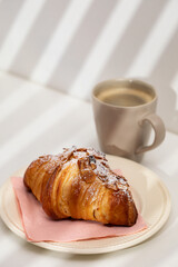 Homemade almond croissant and coffee
