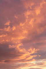 Naklejka na ściany i meble Sunset sky, clouds illuminated by the sun. Warm colors.