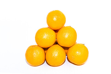 Pyramid of yellow orange ripe tangerines, mandarin on a white background. New year concept