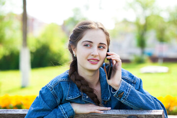 portrait of a young beautiful girl calling by phone