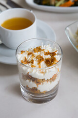 Glass of granola with white cream