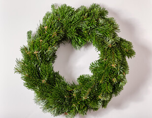 Closeup of a bare fresh and green do it yourself Advent wreath without christmas decoration lying isolated on a white background