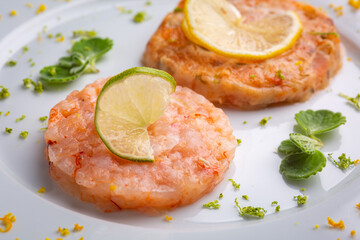 shrimp burger with lemon on white plate