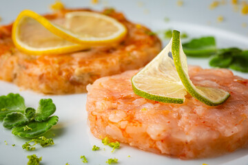 shrimp burger with lemon on white plate