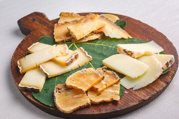 various cheeses on the wooden board isolated on white background
